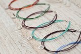 Silver Om anklet with double green
