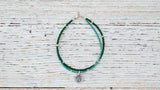 Silver Om bracelet with double green
