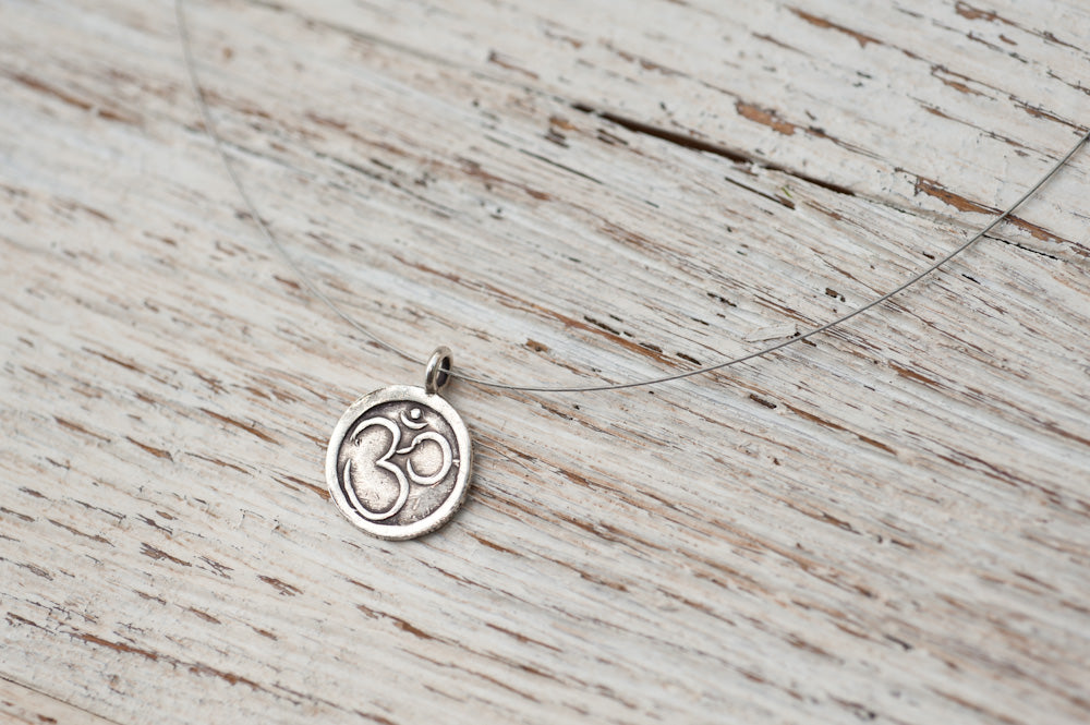 Small Om necklace on delicate silver wire