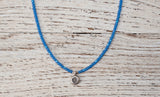 Silver Om necklace with irridescent blue
