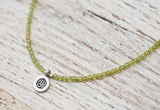 Silver Om necklace with peridot green