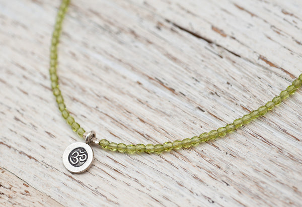 Silver Om necklace with peridot green