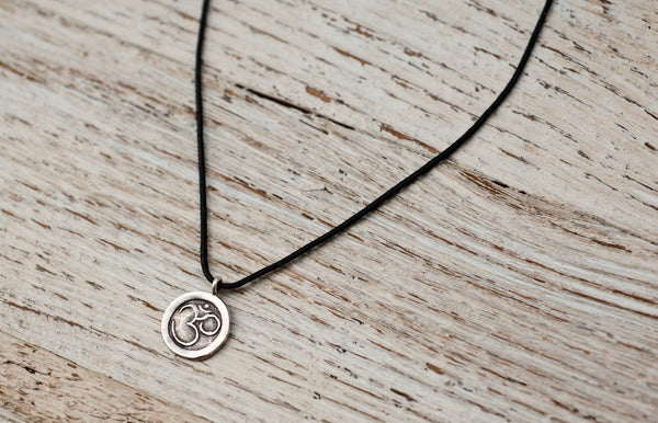 Small Om necklace on black cord