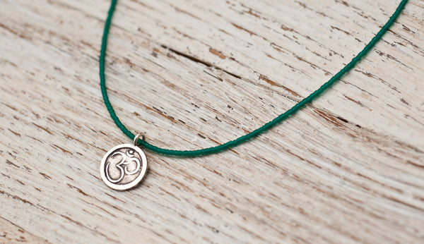 Small Om necklace with emerald green