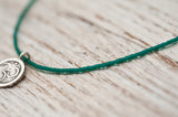 Small Om necklace with emerald green